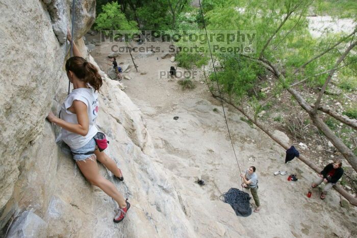 Charlotte Sanders top rope climbing Diving for Rocks (5.10d), photographed from  the third bolt of Magster (5.10a).  It was another long day of rock climbing at Seismic Wall on Austin's Barton Creek Greenbelt, Saturday, April 11, 2009.

Filename: SRM_20090411_16340349.JPG
Aperture: f/5.6
Shutter Speed: 1/320
Body: Canon EOS-1D Mark II
Lens: Canon EF 16-35mm f/2.8 L