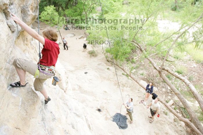 Kirsten Viering top rope climbing Diving for Rocks (5.10d), photographed from  the third bolt of Magster (5.10a).  It was another long day of rock climbing at Seismic Wall on Austin's Barton Creek Greenbelt, Saturday, April 11, 2009.

Filename: SRM_20090411_16364658.JPG
Aperture: f/5.6
Shutter Speed: 1/200
Body: Canon EOS-1D Mark II
Lens: Canon EF 16-35mm f/2.8 L