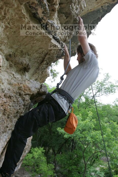 Andrew Dreher top rope climbing Diving for Rocks (5.10d), photographed from  the third bolt of Magster (5.10a).  It was another long day of rock climbing at Seismic Wall on Austin's Barton Creek Greenbelt, Saturday, April 11, 2009.

Filename: SRM_20090411_16425507.JPG
Aperture: f/5.6
Shutter Speed: 1/320
Body: Canon EOS-1D Mark II
Lens: Canon EF 16-35mm f/2.8 L