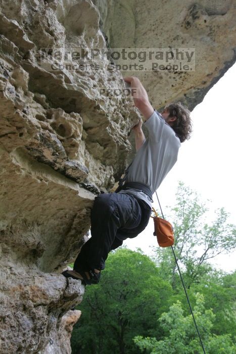 Andrew Dreher top rope climbing Diving for Rocks (5.10d), photographed from  the third bolt of Magster (5.10a).  It was another long day of rock climbing at Seismic Wall on Austin's Barton Creek Greenbelt, Saturday, April 11, 2009.

Filename: SRM_20090411_16430212.JPG
Aperture: f/5.6
Shutter Speed: 1/320
Body: Canon EOS-1D Mark II
Lens: Canon EF 16-35mm f/2.8 L