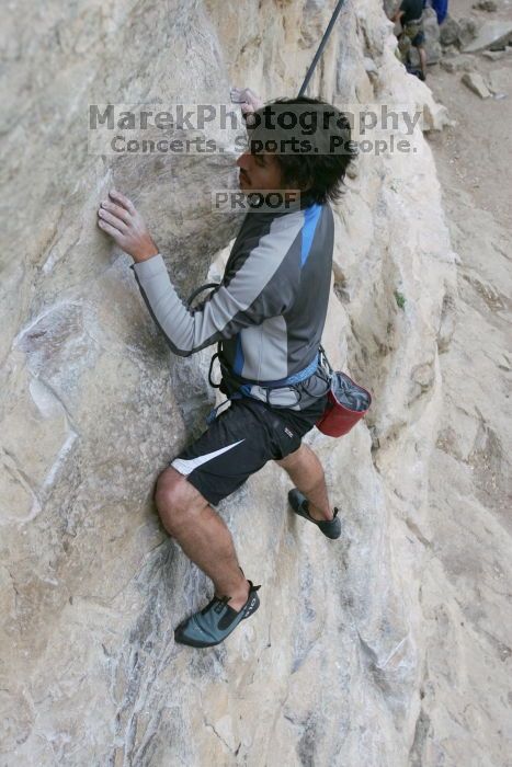 Javier Morales top rope climbing Diving for Rocks (5.10d), photographed from  the third bolt of Magster (5.10a).  It was another long day of rock climbing at Seismic Wall on Austin's Barton Creek Greenbelt, Saturday, April 11, 2009.

Filename: SRM_20090411_16481615.JPG
Aperture: f/5.6
Shutter Speed: 1/320
Body: Canon EOS-1D Mark II
Lens: Canon EF 16-35mm f/2.8 L