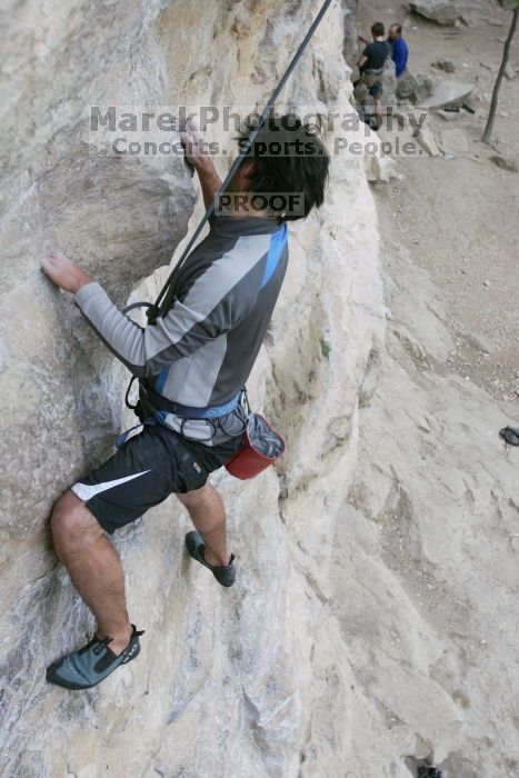 Javier Morales top rope climbing Diving for Rocks (5.10d), photographed from  the third bolt of Magster (5.10a).  It was another long day of rock climbing at Seismic Wall on Austin's Barton Creek Greenbelt, Saturday, April 11, 2009.

Filename: SRM_20090411_16481818.JPG
Aperture: f/5.6
Shutter Speed: 1/320
Body: Canon EOS-1D Mark II
Lens: Canon EF 16-35mm f/2.8 L