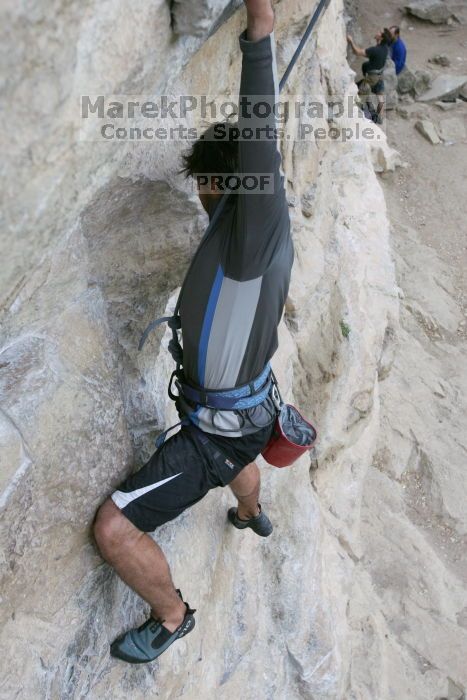 Javier Morales top rope climbing Diving for Rocks (5.10d), photographed from  the third bolt of Magster (5.10a).  It was another long day of rock climbing at Seismic Wall on Austin's Barton Creek Greenbelt, Saturday, April 11, 2009.

Filename: SRM_20090411_16482320.JPG
Aperture: f/5.6
Shutter Speed: 1/320
Body: Canon EOS-1D Mark II
Lens: Canon EF 16-35mm f/2.8 L