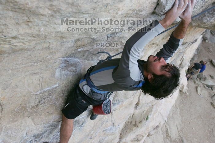 Javier Morales top rope climbing Diving for Rocks (5.10d), photographed from  the third bolt of Magster (5.10a).  It was another long day of rock climbing at Seismic Wall on Austin's Barton Creek Greenbelt, Saturday, April 11, 2009.

Filename: SRM_20090411_16483223.JPG
Aperture: f/5.6
Shutter Speed: 1/320
Body: Canon EOS-1D Mark II
Lens: Canon EF 16-35mm f/2.8 L