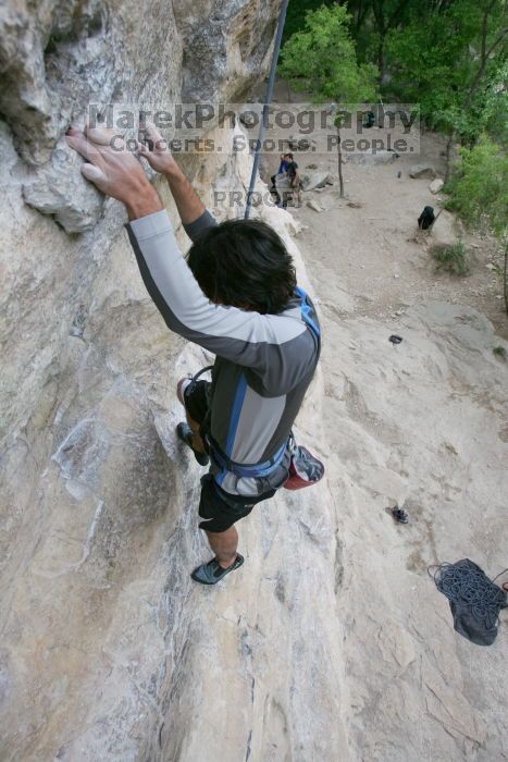 Javier Morales top rope climbing Diving for Rocks (5.10d), photographed from  the third bolt of Magster (5.10a).  It was another long day of rock climbing at Seismic Wall on Austin's Barton Creek Greenbelt, Saturday, April 11, 2009.

Filename: SRM_20090411_16483925.JPG
Aperture: f/5.6
Shutter Speed: 1/320
Body: Canon EOS-1D Mark II
Lens: Canon EF 16-35mm f/2.8 L