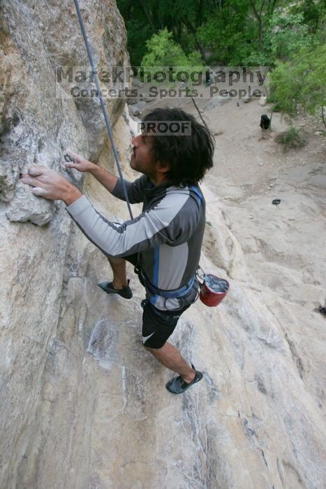 Javier Morales top rope climbing Diving for Rocks (5.10d), photographed from  the third bolt of Magster (5.10a).  It was another long day of rock climbing at Seismic Wall on Austin's Barton Creek Greenbelt, Saturday, April 11, 2009.

Filename: SRM_20090411_16485131.JPG
Aperture: f/5.6
Shutter Speed: 1/320
Body: Canon EOS-1D Mark II
Lens: Canon EF 16-35mm f/2.8 L