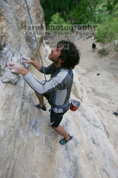 Javier Morales top rope climbing Diving for Rocks (5.10d), photographed from  the third bolt of Magster (5.10a).  It was another long day of rock climbing at Seismic Wall on Austin's Barton Creek Greenbelt, Saturday, April 11, 2009.

Filename: SRM_20090411_16485132.JPG
Aperture: f/5.6
Shutter Speed: 1/320
Body: Canon EOS-1D Mark II
Lens: Canon EF 16-35mm f/2.8 L