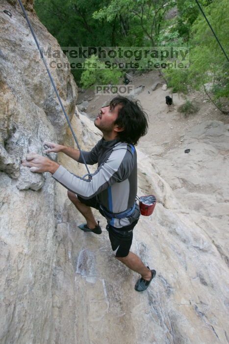 Javier Morales top rope climbing Diving for Rocks (5.10d), photographed from  the third bolt of Magster (5.10a).  It was another long day of rock climbing at Seismic Wall on Austin's Barton Creek Greenbelt, Saturday, April 11, 2009.

Filename: SRM_20090411_16485133.JPG
Aperture: f/5.6
Shutter Speed: 1/320
Body: Canon EOS-1D Mark II
Lens: Canon EF 16-35mm f/2.8 L