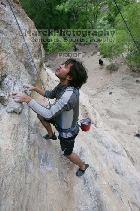 Javier Morales top rope climbing Diving for Rocks (5.10d), photographed from  the third bolt of Magster (5.10a).  It was another long day of rock climbing at Seismic Wall on Austin's Barton Creek Greenbelt, Saturday, April 11, 2009.

Filename: SRM_20090411_16485134.JPG
Aperture: f/5.6
Shutter Speed: 1/320
Body: Canon EOS-1D Mark II
Lens: Canon EF 16-35mm f/2.8 L