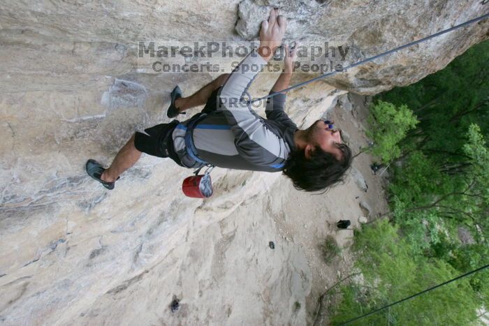 Javier Morales top rope climbing Diving for Rocks (5.10d), photographed from  the third bolt of Magster (5.10a).  It was another long day of rock climbing at Seismic Wall on Austin's Barton Creek Greenbelt, Saturday, April 11, 2009.

Filename: SRM_20090411_16485135.JPG
Aperture: f/5.6
Shutter Speed: 1/320
Body: Canon EOS-1D Mark II
Lens: Canon EF 16-35mm f/2.8 L