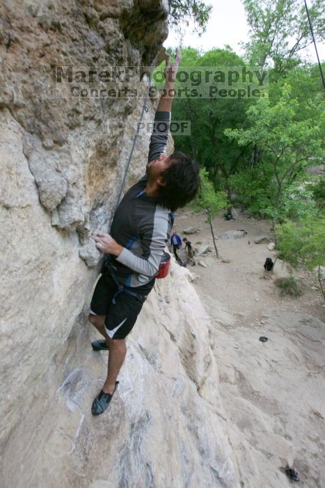 Javier Morales top rope climbing Diving for Rocks (5.10d), photographed from  the third bolt of Magster (5.10a).  It was another long day of rock climbing at Seismic Wall on Austin's Barton Creek Greenbelt, Saturday, April 11, 2009.

Filename: SRM_20090411_16485337.JPG
Aperture: f/5.6
Shutter Speed: 1/320
Body: Canon EOS-1D Mark II
Lens: Canon EF 16-35mm f/2.8 L