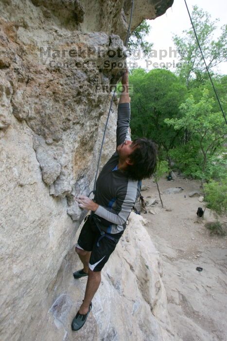 Javier Morales top rope climbing Diving for Rocks (5.10d), photographed from  the third bolt of Magster (5.10a).  It was another long day of rock climbing at Seismic Wall on Austin's Barton Creek Greenbelt, Saturday, April 11, 2009.

Filename: SRM_20090411_16485439.JPG
Aperture: f/5.6
Shutter Speed: 1/320
Body: Canon EOS-1D Mark II
Lens: Canon EF 16-35mm f/2.8 L