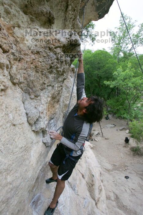 Javier Morales top rope climbing Diving for Rocks (5.10d), photographed from  the third bolt of Magster (5.10a).  It was another long day of rock climbing at Seismic Wall on Austin's Barton Creek Greenbelt, Saturday, April 11, 2009.

Filename: SRM_20090411_16485440.JPG
Aperture: f/5.6
Shutter Speed: 1/320
Body: Canon EOS-1D Mark II
Lens: Canon EF 16-35mm f/2.8 L