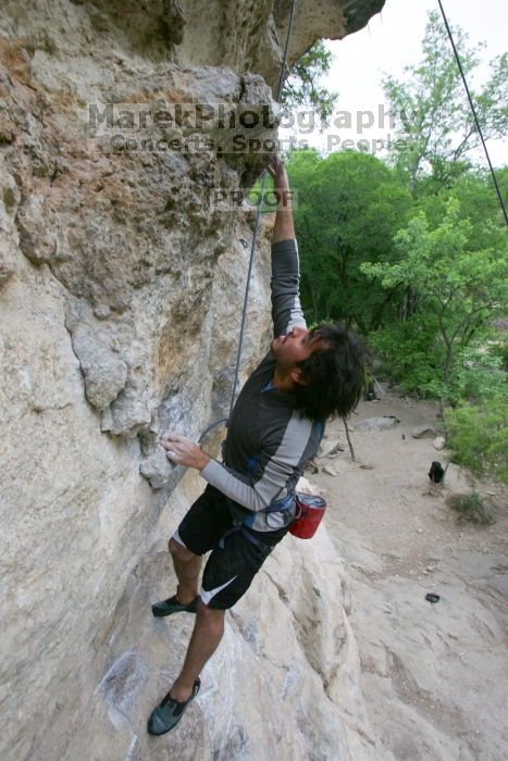 Javier Morales top rope climbing Diving for Rocks (5.10d), photographed from  the third bolt of Magster (5.10a).  It was another long day of rock climbing at Seismic Wall on Austin's Barton Creek Greenbelt, Saturday, April 11, 2009.

Filename: SRM_20090411_16485441.JPG
Aperture: f/5.6
Shutter Speed: 1/320
Body: Canon EOS-1D Mark II
Lens: Canon EF 16-35mm f/2.8 L