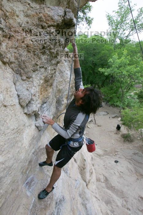 Javier Morales top rope climbing Diving for Rocks (5.10d), photographed from  the third bolt of Magster (5.10a).  It was another long day of rock climbing at Seismic Wall on Austin's Barton Creek Greenbelt, Saturday, April 11, 2009.

Filename: SRM_20090411_16485442.JPG
Aperture: f/5.6
Shutter Speed: 1/320
Body: Canon EOS-1D Mark II
Lens: Canon EF 16-35mm f/2.8 L