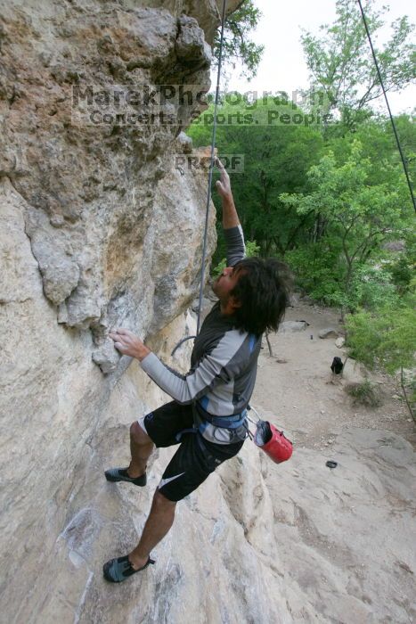 Javier Morales top rope climbing Diving for Rocks (5.10d), photographed from  the third bolt of Magster (5.10a).  It was another long day of rock climbing at Seismic Wall on Austin's Barton Creek Greenbelt, Saturday, April 11, 2009.

Filename: SRM_20090411_16485443.JPG
Aperture: f/5.6
Shutter Speed: 1/320
Body: Canon EOS-1D Mark II
Lens: Canon EF 16-35mm f/2.8 L