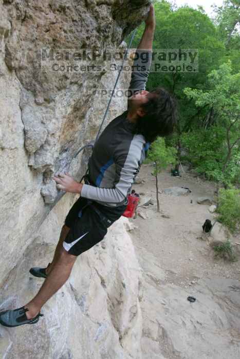 Javier Morales top rope climbing Diving for Rocks (5.10d), photographed from  the third bolt of Magster (5.10a).  It was another long day of rock climbing at Seismic Wall on Austin's Barton Creek Greenbelt, Saturday, April 11, 2009.

Filename: SRM_20090411_16491448.JPG
Aperture: f/5.6
Shutter Speed: 1/320
Body: Canon EOS-1D Mark II
Lens: Canon EF 16-35mm f/2.8 L