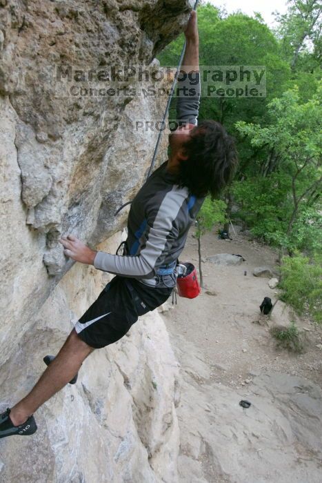 Javier Morales top rope climbing Diving for Rocks (5.10d), photographed from  the third bolt of Magster (5.10a).  It was another long day of rock climbing at Seismic Wall on Austin's Barton Creek Greenbelt, Saturday, April 11, 2009.

Filename: SRM_20090411_16491549.JPG
Aperture: f/5.6
Shutter Speed: 1/320
Body: Canon EOS-1D Mark II
Lens: Canon EF 16-35mm f/2.8 L