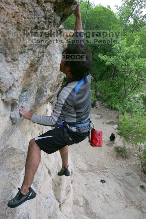 Javier Morales top rope climbing Diving for Rocks (5.10d), photographed from  the third bolt of Magster (5.10a).  It was another long day of rock climbing at Seismic Wall on Austin's Barton Creek Greenbelt, Saturday, April 11, 2009.

Filename: SRM_20090411_16491551.JPG
Aperture: f/5.6
Shutter Speed: 1/320
Body: Canon EOS-1D Mark II
Lens: Canon EF 16-35mm f/2.8 L