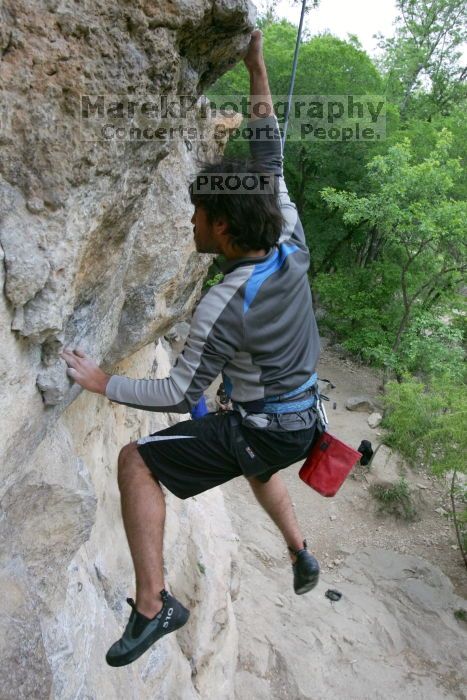 Javier Morales top rope climbing Diving for Rocks (5.10d), photographed from  the third bolt of Magster (5.10a).  It was another long day of rock climbing at Seismic Wall on Austin's Barton Creek Greenbelt, Saturday, April 11, 2009.

Filename: SRM_20090411_16491552.JPG
Aperture: f/5.6
Shutter Speed: 1/320
Body: Canon EOS-1D Mark II
Lens: Canon EF 16-35mm f/2.8 L