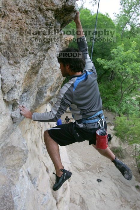 Javier Morales top rope climbing Diving for Rocks (5.10d), photographed from  the third bolt of Magster (5.10a).  It was another long day of rock climbing at Seismic Wall on Austin's Barton Creek Greenbelt, Saturday, April 11, 2009.

Filename: SRM_20090411_16491554.JPG
Aperture: f/5.6
Shutter Speed: 1/320
Body: Canon EOS-1D Mark II
Lens: Canon EF 16-35mm f/2.8 L