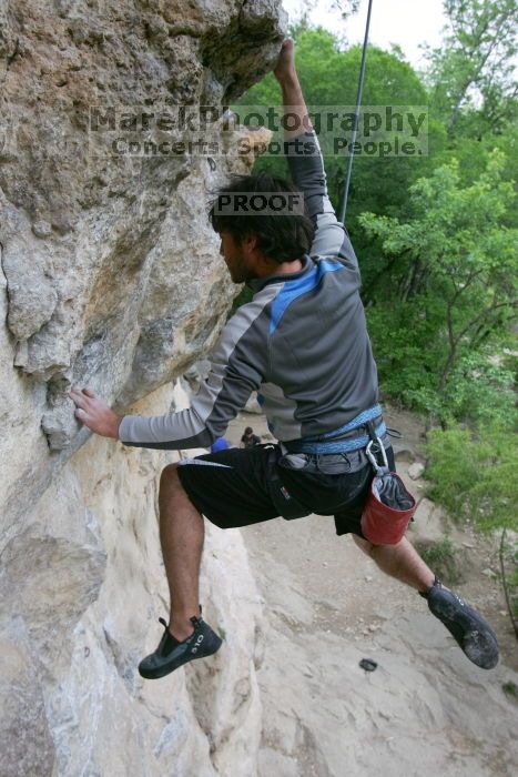 Javier Morales top rope climbing Diving for Rocks (5.10d), photographed from  the third bolt of Magster (5.10a).  It was another long day of rock climbing at Seismic Wall on Austin's Barton Creek Greenbelt, Saturday, April 11, 2009.

Filename: SRM_20090411_16491555.JPG
Aperture: f/5.6
Shutter Speed: 1/320
Body: Canon EOS-1D Mark II
Lens: Canon EF 16-35mm f/2.8 L