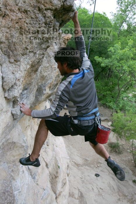 Javier Morales top rope climbing Diving for Rocks (5.10d), photographed from  the third bolt of Magster (5.10a).  It was another long day of rock climbing at Seismic Wall on Austin's Barton Creek Greenbelt, Saturday, April 11, 2009.

Filename: SRM_20090411_16491556.JPG
Aperture: f/5.6
Shutter Speed: 1/320
Body: Canon EOS-1D Mark II
Lens: Canon EF 16-35mm f/2.8 L