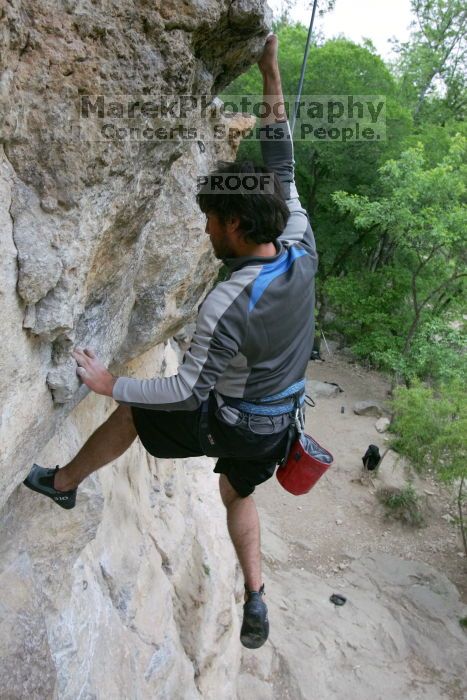 Javier Morales top rope climbing Diving for Rocks (5.10d), photographed from  the third bolt of Magster (5.10a).  It was another long day of rock climbing at Seismic Wall on Austin's Barton Creek Greenbelt, Saturday, April 11, 2009.

Filename: SRM_20090411_16491657.JPG
Aperture: f/5.6
Shutter Speed: 1/320
Body: Canon EOS-1D Mark II
Lens: Canon EF 16-35mm f/2.8 L