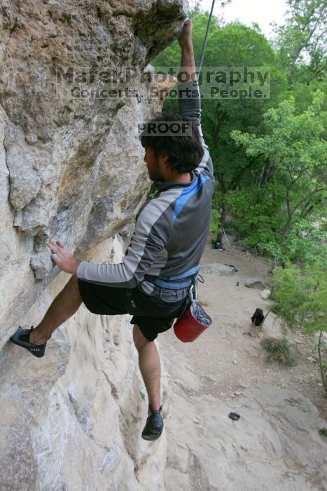 Javier Morales top rope climbing Diving for Rocks (5.10d), photographed from  the third bolt of Magster (5.10a).  It was another long day of rock climbing at Seismic Wall on Austin's Barton Creek Greenbelt, Saturday, April 11, 2009.

Filename: SRM_20090411_16491658.JPG
Aperture: f/5.6
Shutter Speed: 1/320
Body: Canon EOS-1D Mark II
Lens: Canon EF 16-35mm f/2.8 L