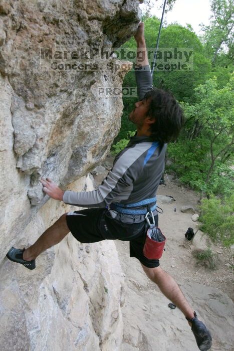 Javier Morales top rope climbing Diving for Rocks (5.10d), photographed from  the third bolt of Magster (5.10a).  It was another long day of rock climbing at Seismic Wall on Austin's Barton Creek Greenbelt, Saturday, April 11, 2009.

Filename: SRM_20090411_16491761.JPG
Aperture: f/5.6
Shutter Speed: 1/320
Body: Canon EOS-1D Mark II
Lens: Canon EF 16-35mm f/2.8 L