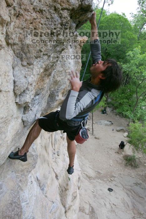 Javier Morales top rope climbing Diving for Rocks (5.10d), photographed from  the third bolt of Magster (5.10a).  It was another long day of rock climbing at Seismic Wall on Austin's Barton Creek Greenbelt, Saturday, April 11, 2009.

Filename: SRM_20090411_16491862.JPG
Aperture: f/5.6
Shutter Speed: 1/320
Body: Canon EOS-1D Mark II
Lens: Canon EF 16-35mm f/2.8 L