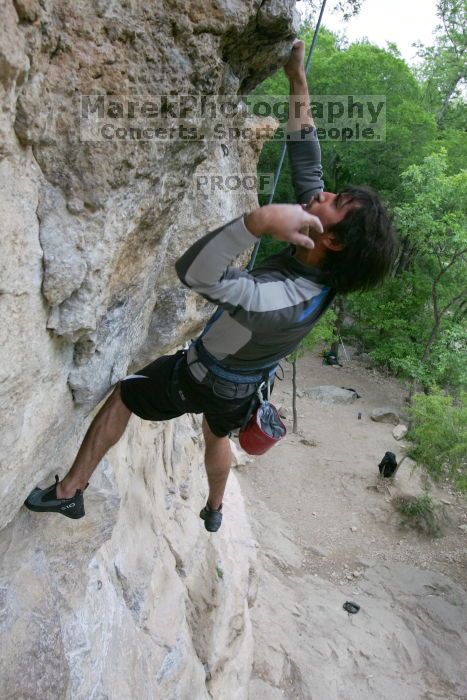 Javier Morales top rope climbing Diving for Rocks (5.10d), photographed from  the third bolt of Magster (5.10a).  It was another long day of rock climbing at Seismic Wall on Austin's Barton Creek Greenbelt, Saturday, April 11, 2009.

Filename: SRM_20090411_16491863.JPG
Aperture: f/5.6
Shutter Speed: 1/320
Body: Canon EOS-1D Mark II
Lens: Canon EF 16-35mm f/2.8 L