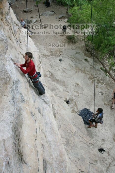 Me top rope climbing Diving for Rocks (5.10d) with Javier Morales belaying, photographed from  the third bolt of Magster (5.10a) by Andrew Dreher.  It was another long day of rock climbing at Seismic Wall on Austin's Barton Creek Greenbelt, Saturday, April 11, 2009.

Filename: SRM_20090411_17025872.JPG
Aperture: f/5.6
Shutter Speed: 1/250
Body: Canon EOS-1D Mark II
Lens: Canon EF 16-35mm f/2.8 L