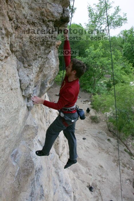 Me top rope climbing Diving for Rocks (5.10d), photographed from  the third bolt of Magster (5.10a) by Andrew Dreher.  It was another long day of rock climbing at Seismic Wall on Austin's Barton Creek Greenbelt, Saturday, April 11, 2009.

Filename: SRM_20090411_17051198.JPG
Aperture: f/5.6
Shutter Speed: 1/320
Body: Canon EOS-1D Mark II
Lens: Canon EF 16-35mm f/2.8 L