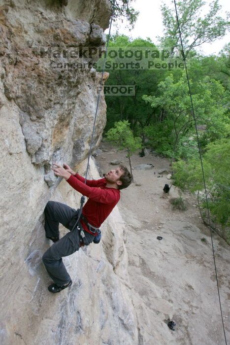 Me top rope climbing Diving for Rocks (5.10d), photographed from  the third bolt of Magster (5.10a) by Andrew Dreher.  It was another long day of rock climbing at Seismic Wall on Austin's Barton Creek Greenbelt, Saturday, April 11, 2009.

Filename: SRM_20090411_17080928.JPG
Aperture: f/5.6
Shutter Speed: 1/320
Body: Canon EOS-1D Mark II
Lens: Canon EF 16-35mm f/2.8 L