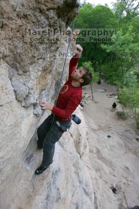 Me top rope climbing Diving for Rocks (5.10d), photographed from  the third bolt of Magster (5.10a) by Andrew Dreher.  It was another long day of rock climbing at Seismic Wall on Austin's Barton Creek Greenbelt, Saturday, April 11, 2009.

Filename: SRM_20090411_17081130.JPG
Aperture: f/5.6
Shutter Speed: 1/320
Body: Canon EOS-1D Mark II
Lens: Canon EF 16-35mm f/2.8 L