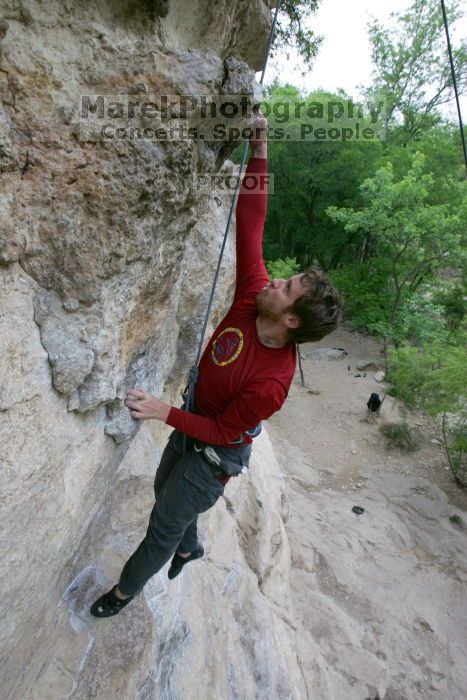 Me top rope climbing Diving for Rocks (5.10d), photographed from  the third bolt of Magster (5.10a) by Andrew Dreher.  It was another long day of rock climbing at Seismic Wall on Austin's Barton Creek Greenbelt, Saturday, April 11, 2009.

Filename: SRM_20090411_17081133.JPG
Aperture: f/5.6
Shutter Speed: 1/320
Body: Canon EOS-1D Mark II
Lens: Canon EF 16-35mm f/2.8 L