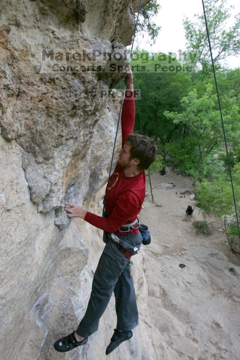 Me top rope climbing Diving for Rocks (5.10d), photographed from  the third bolt of Magster (5.10a) by Andrew Dreher.  It was another long day of rock climbing at Seismic Wall on Austin's Barton Creek Greenbelt, Saturday, April 11, 2009.

Filename: SRM_20090411_17081235.JPG
Aperture: f/5.6
Shutter Speed: 1/320
Body: Canon EOS-1D Mark II
Lens: Canon EF 16-35mm f/2.8 L