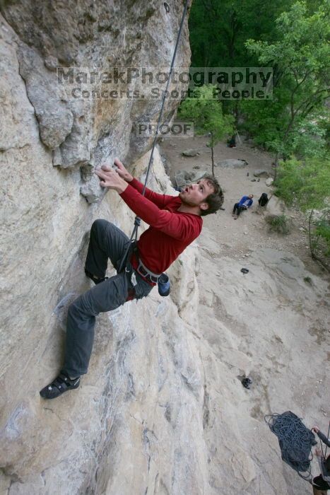 Me top rope climbing Diving for Rocks (5.10d), photographed from  the third bolt of Magster (5.10a) by Andrew Dreher.  It was another long day of rock climbing at Seismic Wall on Austin's Barton Creek Greenbelt, Saturday, April 11, 2009.

Filename: SRM_20090411_17103456.JPG
Aperture: f/5.6
Shutter Speed: 1/320
Body: Canon EOS-1D Mark II
Lens: Canon EF 16-35mm f/2.8 L