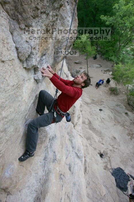 Me top rope climbing Diving for Rocks (5.10d), photographed from  the third bolt of Magster (5.10a) by Andrew Dreher.  It was another long day of rock climbing at Seismic Wall on Austin's Barton Creek Greenbelt, Saturday, April 11, 2009.

Filename: SRM_20090411_17103457.JPG
Aperture: f/5.6
Shutter Speed: 1/320
Body: Canon EOS-1D Mark II
Lens: Canon EF 16-35mm f/2.8 L