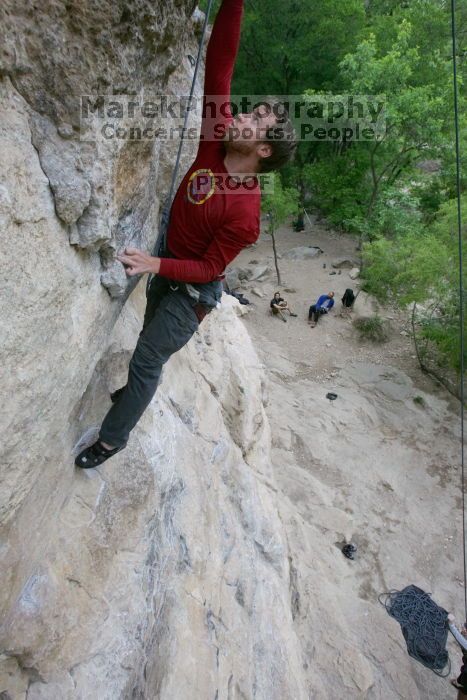 Me top rope climbing Diving for Rocks (5.10d), photographed from  the third bolt of Magster (5.10a) by Andrew Dreher.  It was another long day of rock climbing at Seismic Wall on Austin's Barton Creek Greenbelt, Saturday, April 11, 2009.

Filename: SRM_20090411_17103661.JPG
Aperture: f/5.6
Shutter Speed: 1/320
Body: Canon EOS-1D Mark II
Lens: Canon EF 16-35mm f/2.8 L