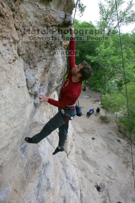 Me top rope climbing Diving for Rocks (5.10d), photographed from  the third bolt of Magster (5.10a) by Andrew Dreher.  It was another long day of rock climbing at Seismic Wall on Austin's Barton Creek Greenbelt, Saturday, April 11, 2009.

Filename: SRM_20090411_17103664.JPG
Aperture: f/5.6
Shutter Speed: 1/320
Body: Canon EOS-1D Mark II
Lens: Canon EF 16-35mm f/2.8 L