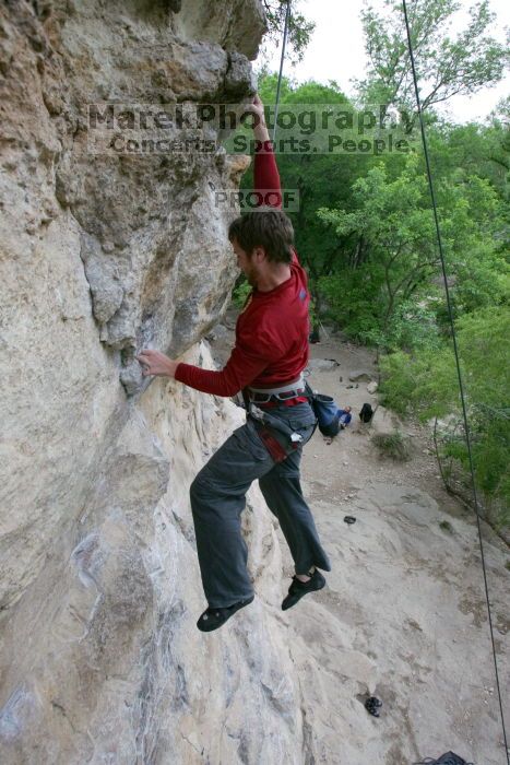 Me top rope climbing Diving for Rocks (5.10d), photographed from  the third bolt of Magster (5.10a) by Andrew Dreher.  It was another long day of rock climbing at Seismic Wall on Austin's Barton Creek Greenbelt, Saturday, April 11, 2009.

Filename: SRM_20090411_17103770.JPG
Aperture: f/5.6
Shutter Speed: 1/320
Body: Canon EOS-1D Mark II
Lens: Canon EF 16-35mm f/2.8 L