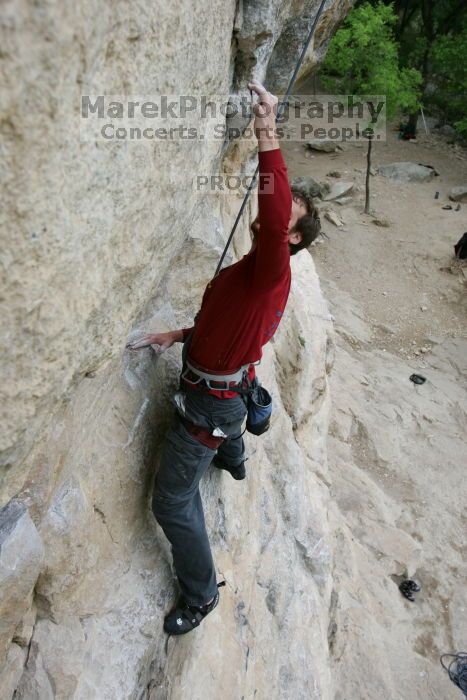 Me top rope climbing Diving for Rocks (5.10d), photographed from  the third bolt of Magster (5.10a) by Andrew Dreher.  It was another long day of rock climbing at Seismic Wall on Austin's Barton Creek Greenbelt, Saturday, April 11, 2009.

Filename: SRM_20090411_17163632.JPG
Aperture: f/5.6
Shutter Speed: 1/320
Body: Canon EOS-1D Mark II
Lens: Canon EF 16-35mm f/2.8 L