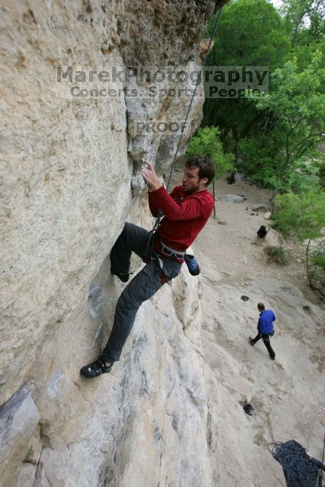 Me top rope climbing Diving for Rocks (5.10d), photographed from  the third bolt of Magster (5.10a) by Andrew Dreher.  It was another long day of rock climbing at Seismic Wall on Austin's Barton Creek Greenbelt, Saturday, April 11, 2009.

Filename: SRM_20090411_17164735.JPG
Aperture: f/5.6
Shutter Speed: 1/320
Body: Canon EOS-1D Mark II
Lens: Canon EF 16-35mm f/2.8 L