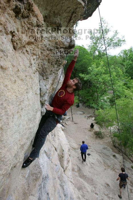 Me top rope climbing Diving for Rocks (5.10d), photographed from  the third bolt of Magster (5.10a) by Andrew Dreher.  It was another long day of rock climbing at Seismic Wall on Austin's Barton Creek Greenbelt, Saturday, April 11, 2009.

Filename: SRM_20090411_17164938.JPG
Aperture: f/5.6
Shutter Speed: 1/320
Body: Canon EOS-1D Mark II
Lens: Canon EF 16-35mm f/2.8 L