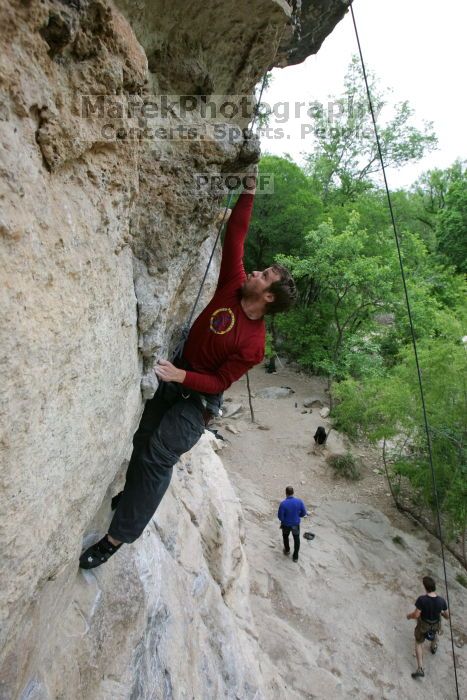 Me top rope climbing Diving for Rocks (5.10d), photographed from  the third bolt of Magster (5.10a) by Andrew Dreher.  It was another long day of rock climbing at Seismic Wall on Austin's Barton Creek Greenbelt, Saturday, April 11, 2009.

Filename: SRM_20090411_17164939.JPG
Aperture: f/5.6
Shutter Speed: 1/320
Body: Canon EOS-1D Mark II
Lens: Canon EF 16-35mm f/2.8 L