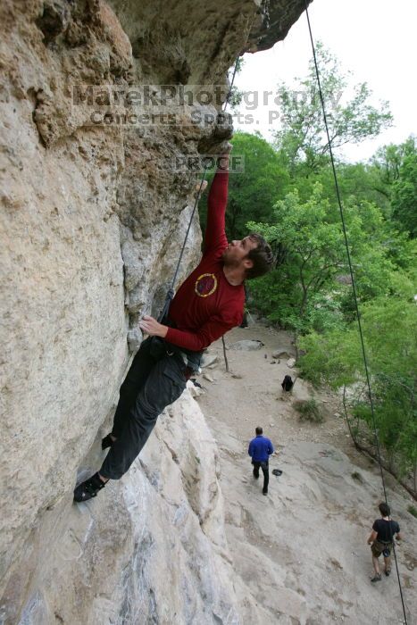 Me top rope climbing Diving for Rocks (5.10d), photographed from  the third bolt of Magster (5.10a) by Andrew Dreher.  It was another long day of rock climbing at Seismic Wall on Austin's Barton Creek Greenbelt, Saturday, April 11, 2009.

Filename: SRM_20090411_17164940.JPG
Aperture: f/5.6
Shutter Speed: 1/320
Body: Canon EOS-1D Mark II
Lens: Canon EF 16-35mm f/2.8 L