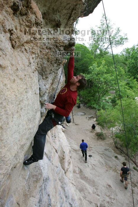 Me top rope climbing Diving for Rocks (5.10d), photographed from  the third bolt of Magster (5.10a) by Andrew Dreher.  It was another long day of rock climbing at Seismic Wall on Austin's Barton Creek Greenbelt, Saturday, April 11, 2009.

Filename: SRM_20090411_17165042.JPG
Aperture: f/5.6
Shutter Speed: 1/320
Body: Canon EOS-1D Mark II
Lens: Canon EF 16-35mm f/2.8 L