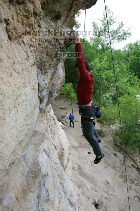 Me top rope climbing Diving for Rocks (5.10d), photographed from  the third bolt of Magster (5.10a) by Andrew Dreher.  It was another long day of rock climbing at Seismic Wall on Austin's Barton Creek Greenbelt, Saturday, April 11, 2009.

Filename: SRM_20090411_17165554.JPG
Aperture: f/5.6
Shutter Speed: 1/320
Body: Canon EOS-1D Mark II
Lens: Canon EF 16-35mm f/2.8 L